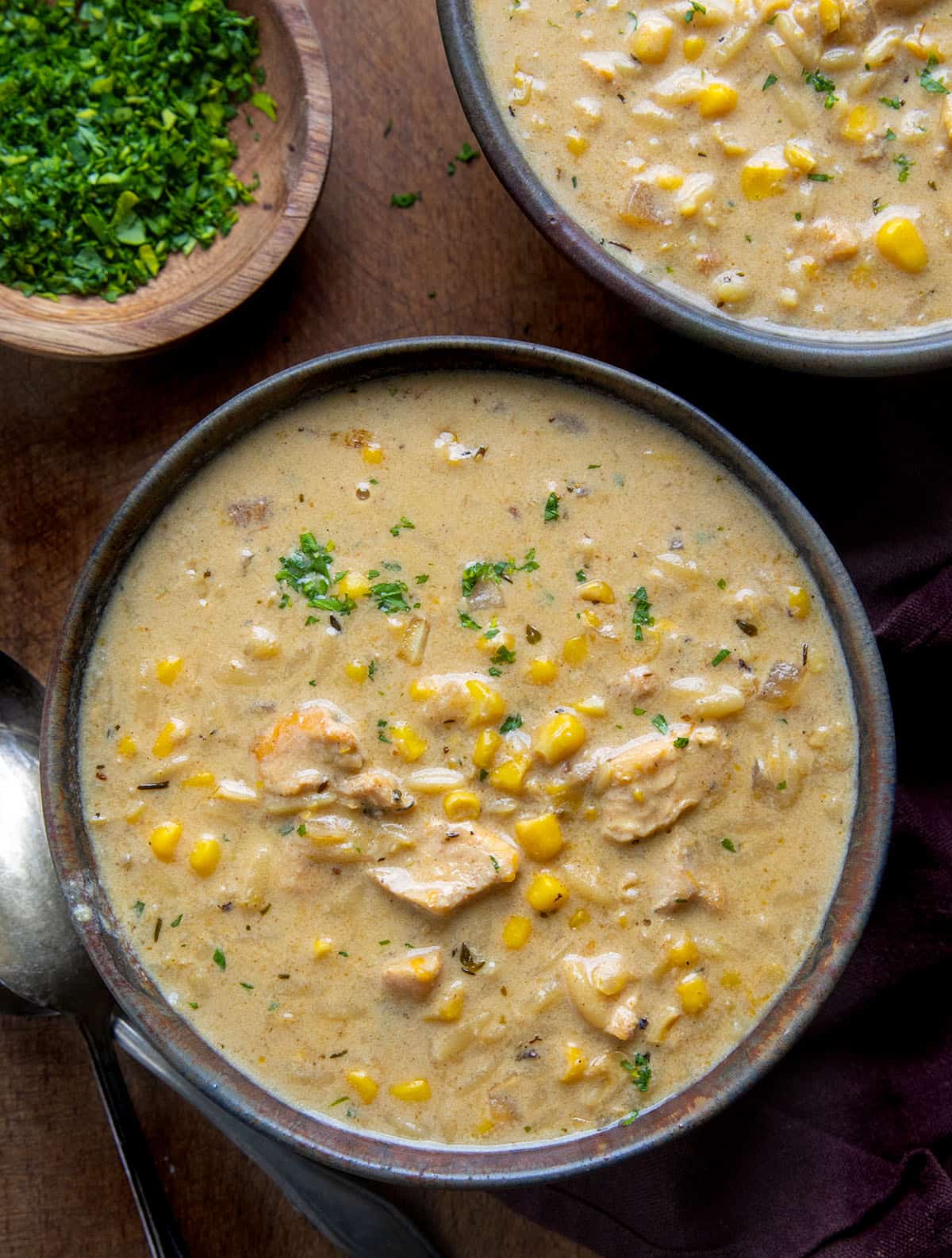 Bowls of Creamy Chicken Corn Orzo Soup on a wooden table from overhead Bowls of Creamy Chicken Corn Orzo Soup on a wooden table from overhead.