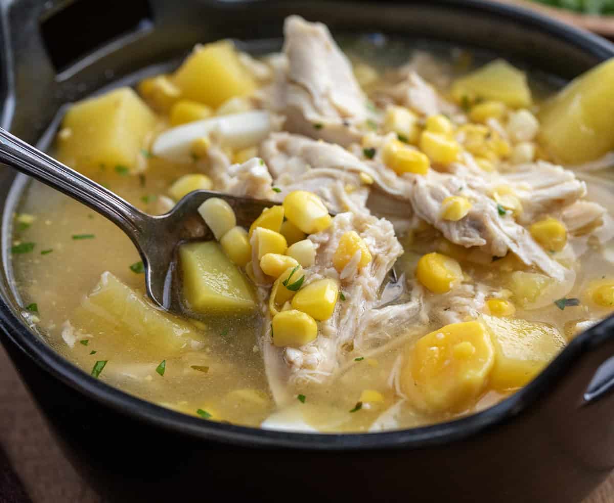 Close up of a black bowl being filled with Pennsylvania Dutch Chicken Corn Soup Close up of a black bowl being filled with Pennsylvania Dutch Chicken Corn Soup.