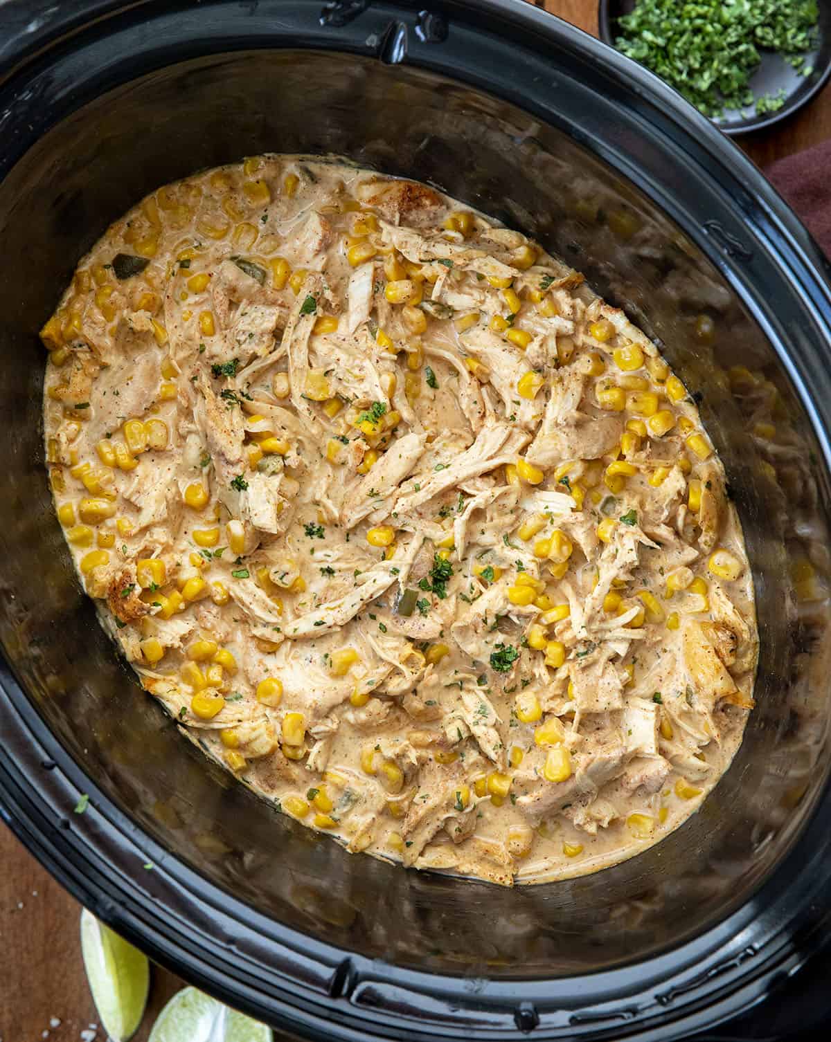 Slow Cooker Street Corn Chicken on a wooden table from overhead Slow Cooker Street Corn Chicken on a wooden table from overhead.