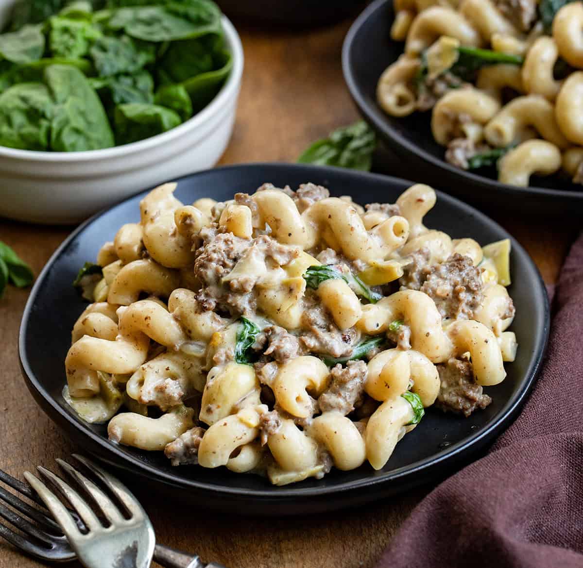 Close up of plates of Spinach Artichoke Hamburger Pasta Close up of plates of Spinach Artichoke Hamburger Pasta.
