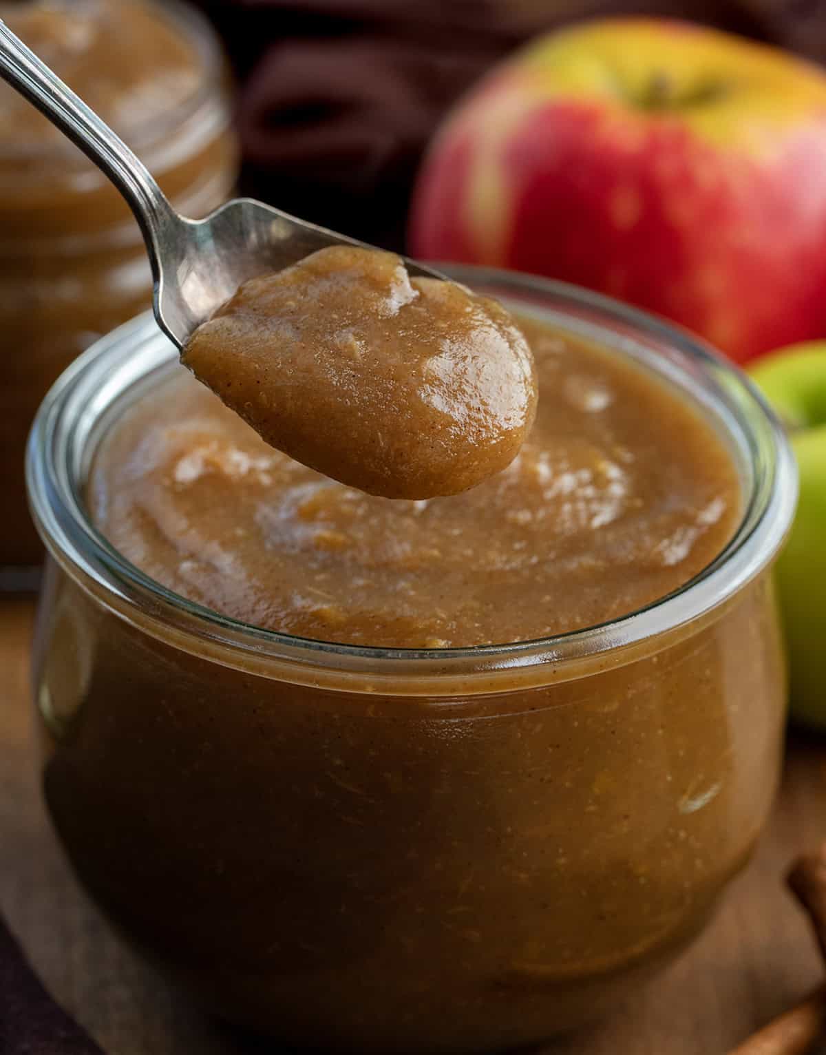 Jar full of Stovetop Apple Butter with a spoonful being held above the jar Jar full of Stovetop Apple Butter with a spoonful being held above the jar.