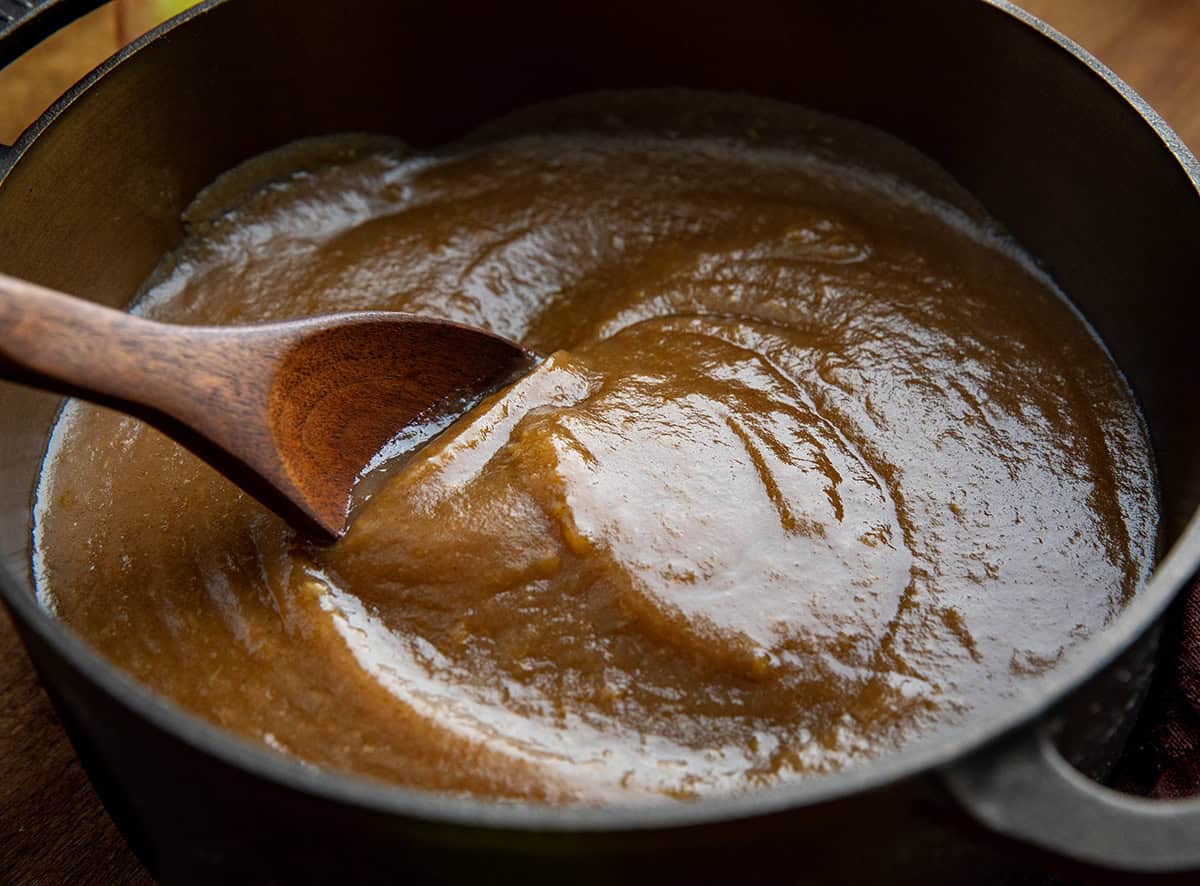Pot of Apple Butter with a wooden spoon stirring it Pot of Apple Butter with a wooden spoon stirring it.