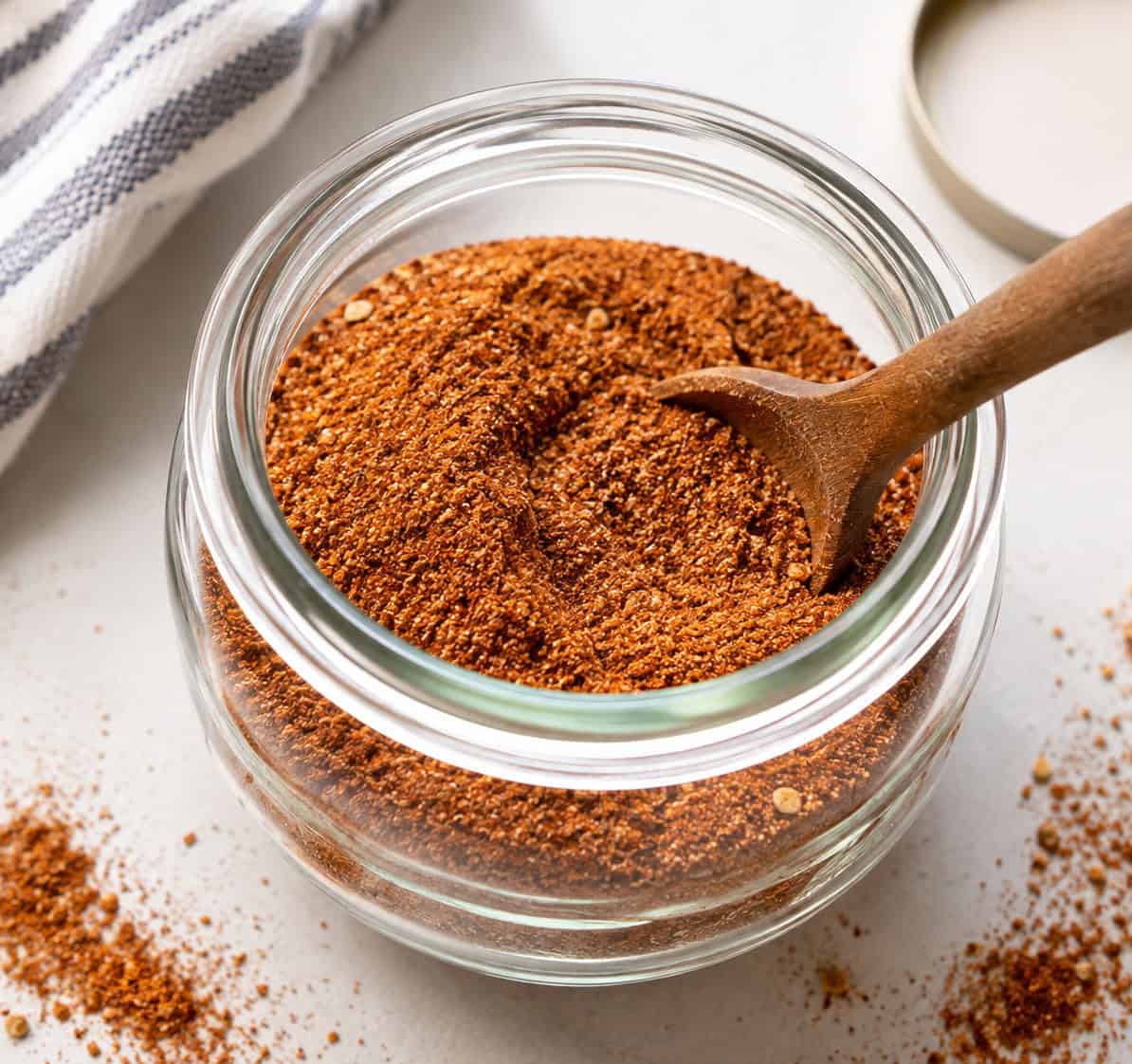 Jar of Taco Seasoning with wooden measuring spoon in it Jar of Taco Seasoning with wooden measuring spoon in it.