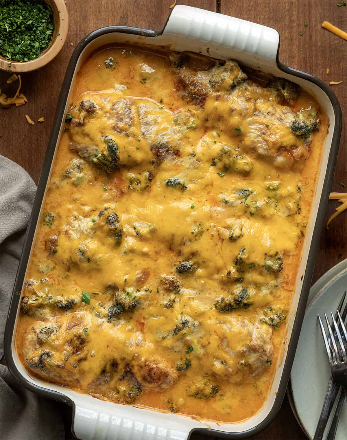 Broccoli Cheddar Chicken Casserole on a wooden table from overhead Broccoli Cheddar Chicken Casserole on a wooden table from overhead.