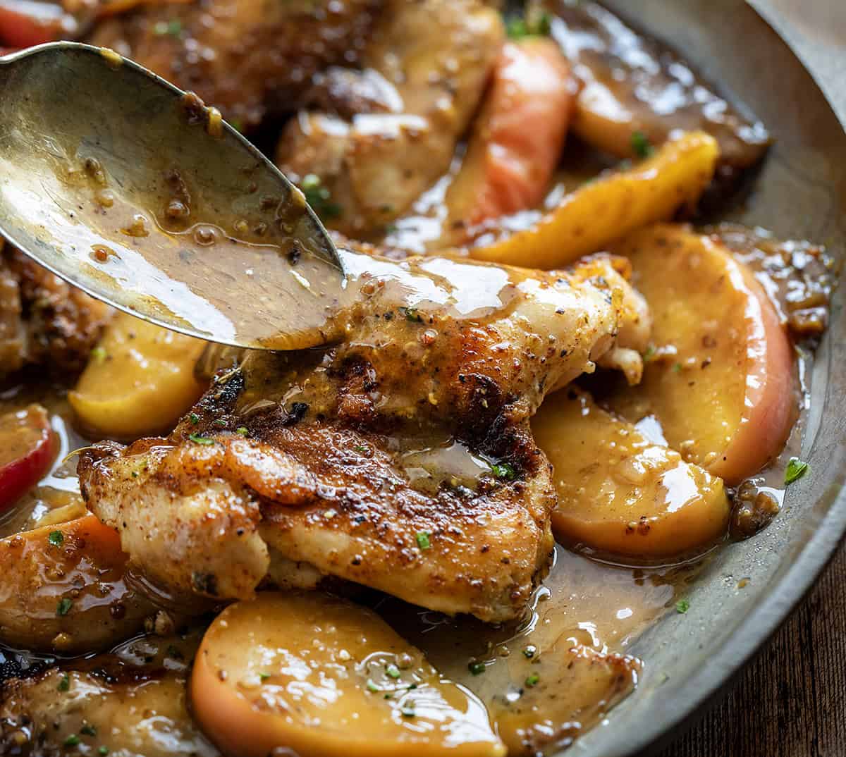 Drizzling sauce over Dijon Apple Shallot Chicken Drizzling sauce over Dijon Apple Shallot Chicken.