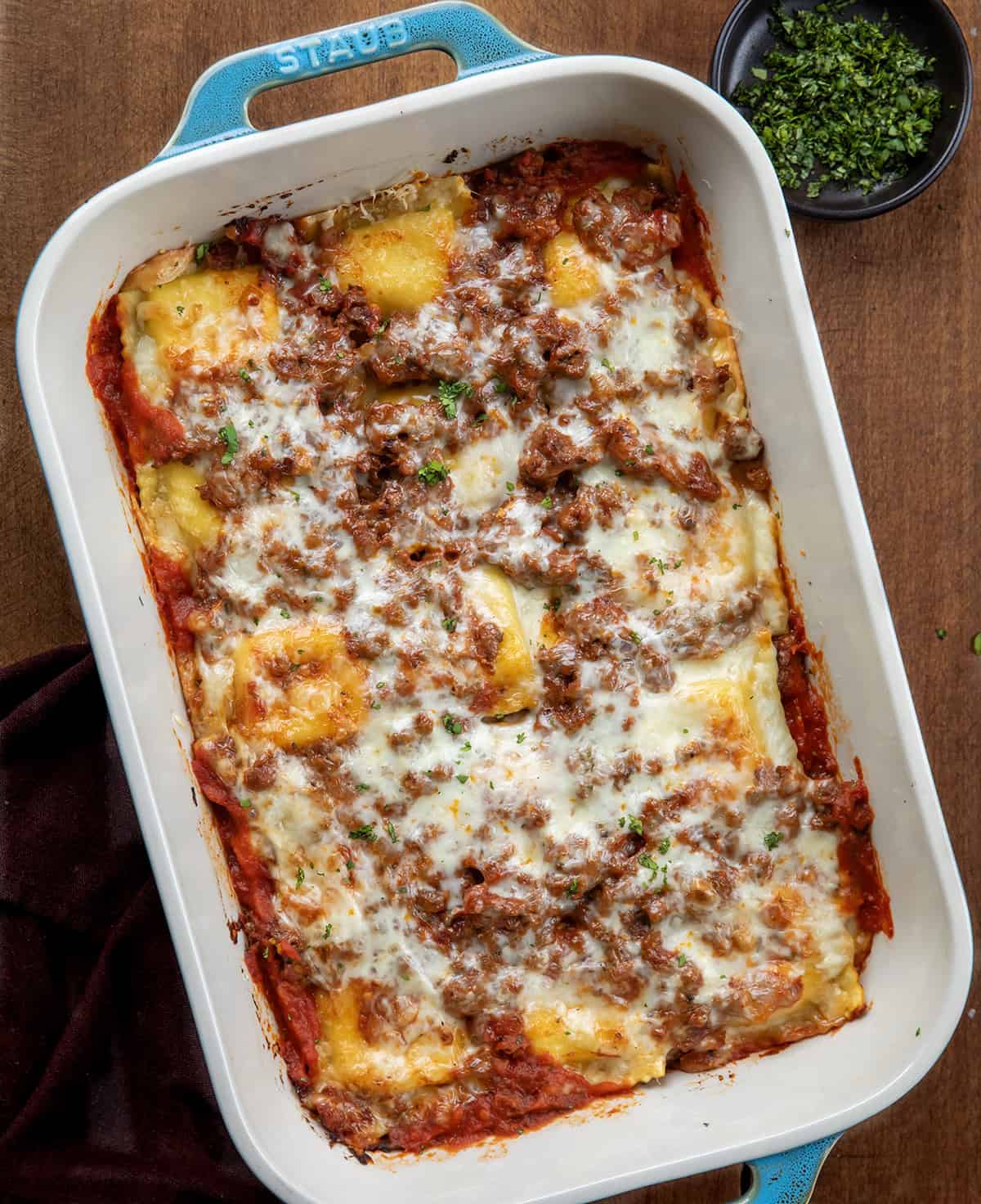 Pan of Easy Baked Ravioli on a wooden table from overhead Pan of Easy Baked Ravioli on a wooden table from overhead.
