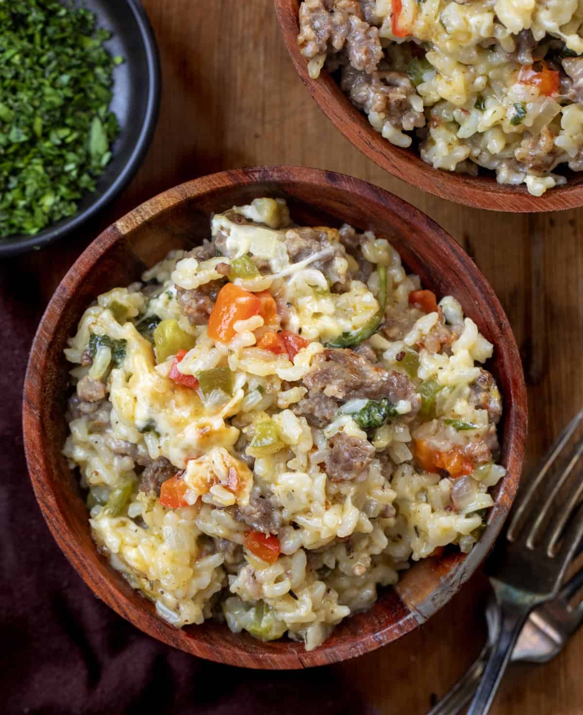Wooden bowls of Italian Sausage and Rice on a wooden table Wooden bowls of Italian Sausage and Rice on a wooden table from overhead.