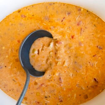 Getting a ladle full of Buffalo Chicken Soup from the crockpot.