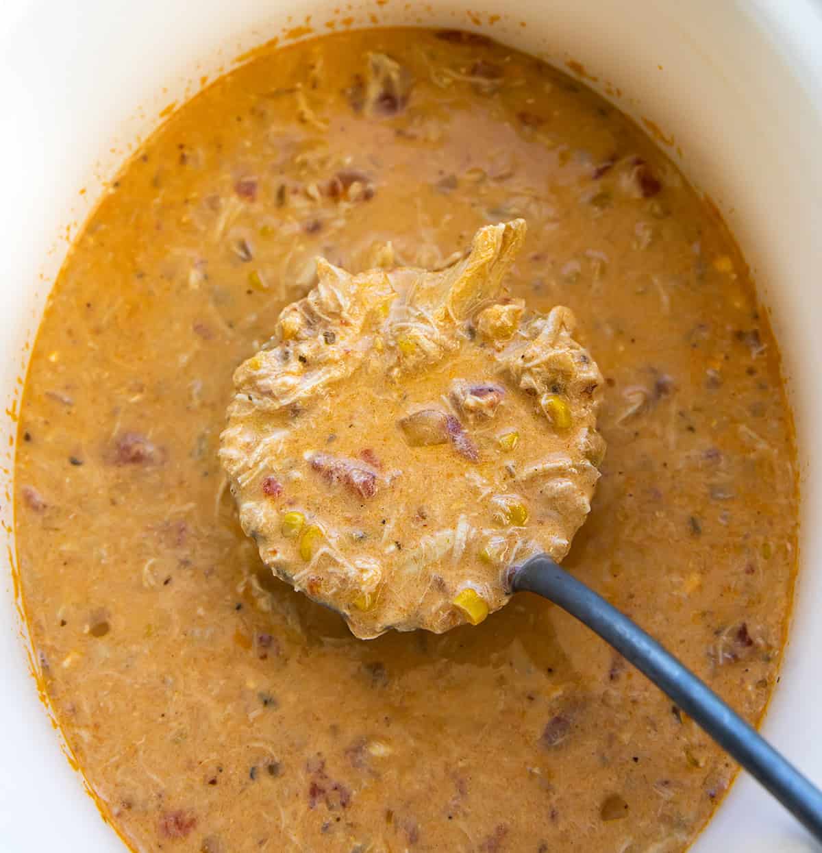 Slow Cooker Buffalo Chicken Soup in the crockpot with a ladle of soup being held above it Slow Cooker Buffalo Chicken Soup in the crockpot with a ladle of soup being held above it.