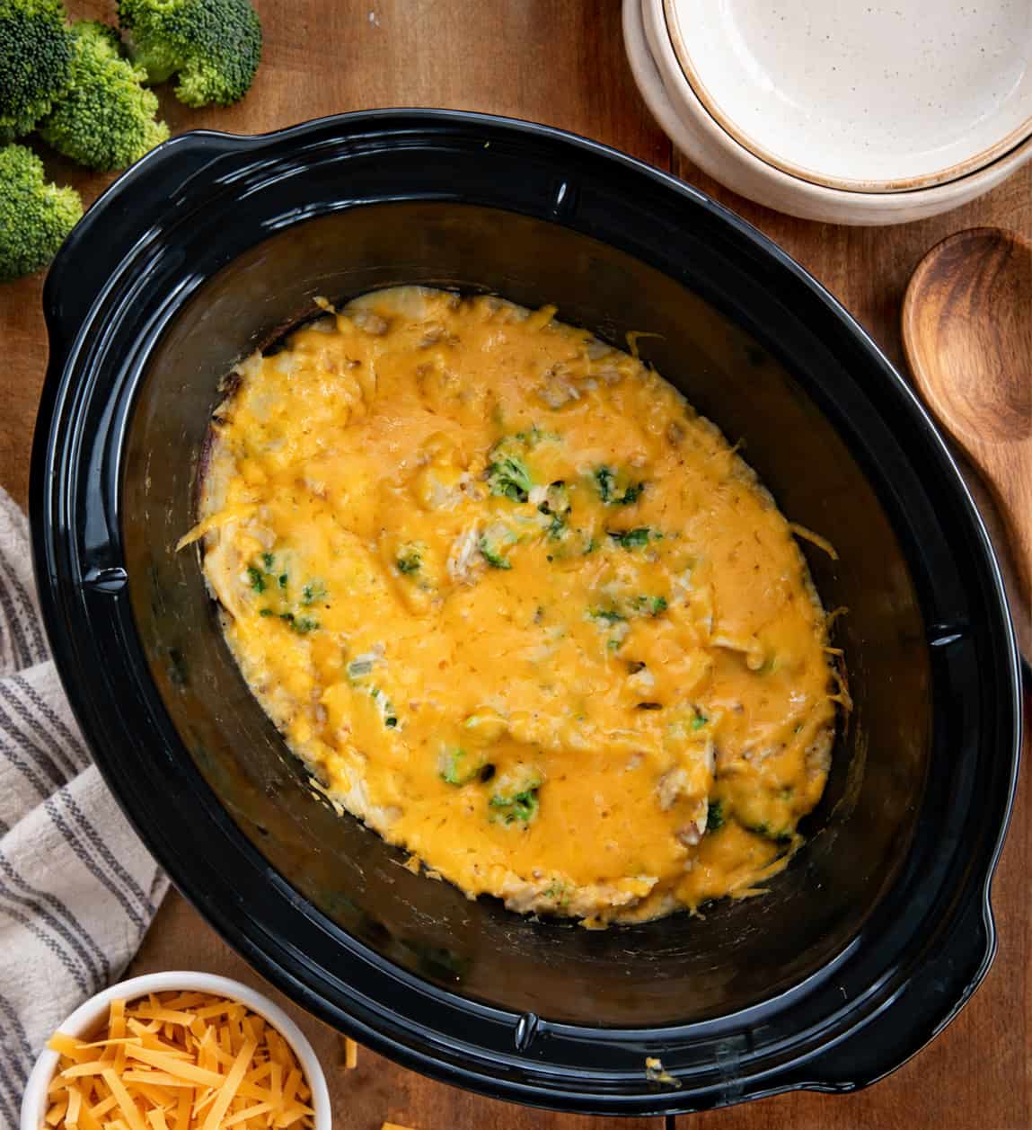 Slow Cooker Chicken Broccoli and Rice on a wooden table from overhead Slow Cooker Chicken Broccoli and Rice on a wooden table from overhead.