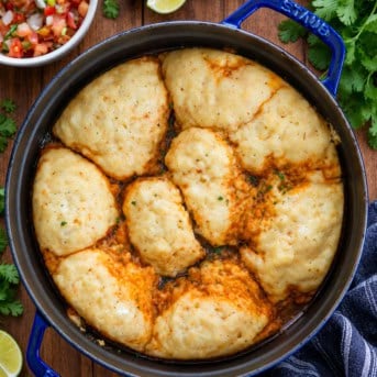 Pot of Southwest Chicken and Dumplings on a wooden table from overhead.