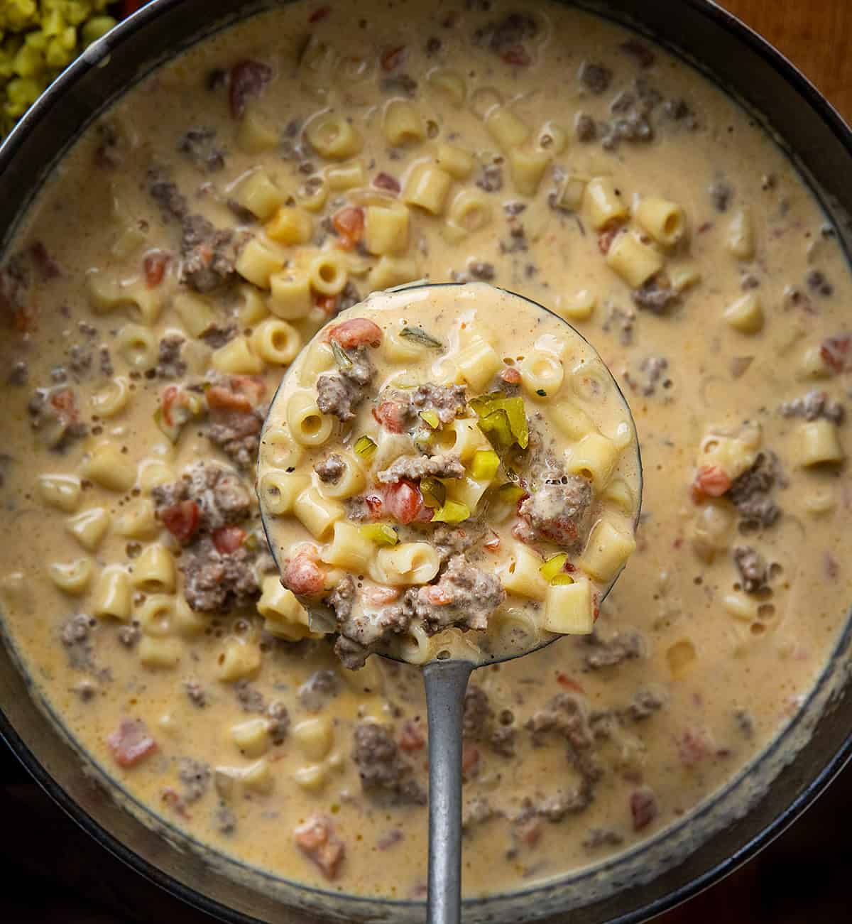 Ladle full of Cheeseburger Pasta Soup being held above the pot Ladle full of Cheeseburger Pasta Soup being held above the pot.