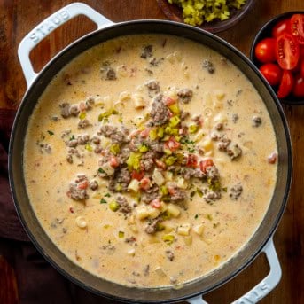 Pot of Cheeseburger Pasta Soup on a wooden table from overhead.