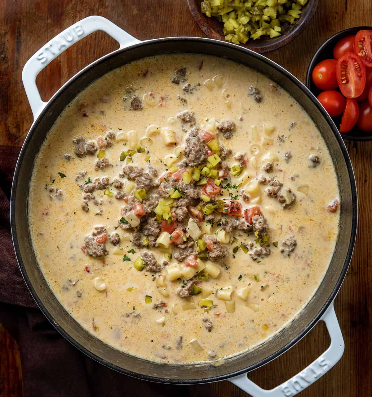 Pot of Cheeseburger Pasta Soup on a wooden table from overhead Pot of Cheeseburger Pasta Soup on a wooden table from overhead.