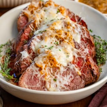 Sliced French Onion Beef Tenderloin on a platter.