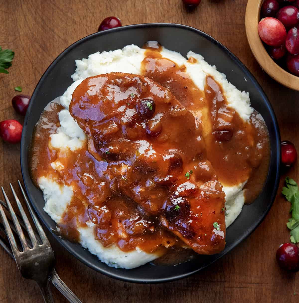 Plate of Slow Cooker Cranberry Chicken on top of a bed of mashed potatoes from overhead.