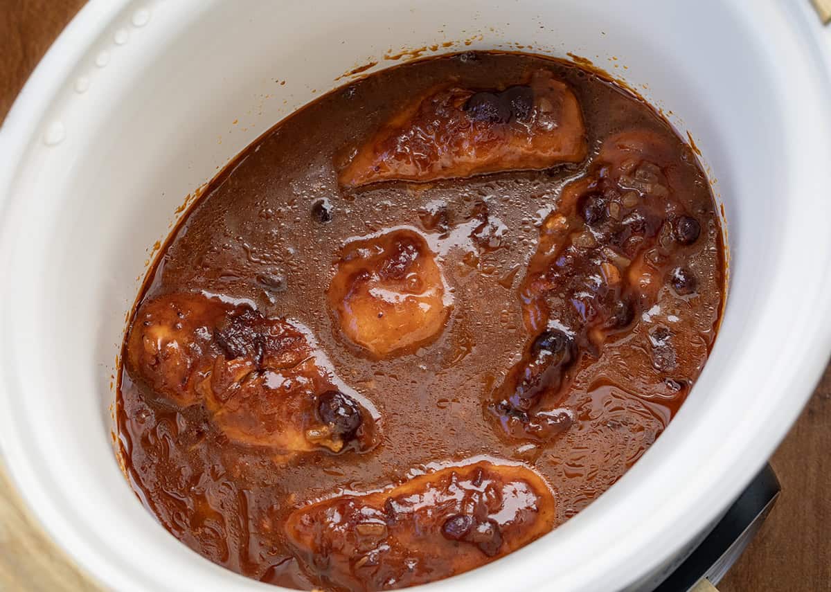 Cranberry Chicken in a white slow cooker close up.
