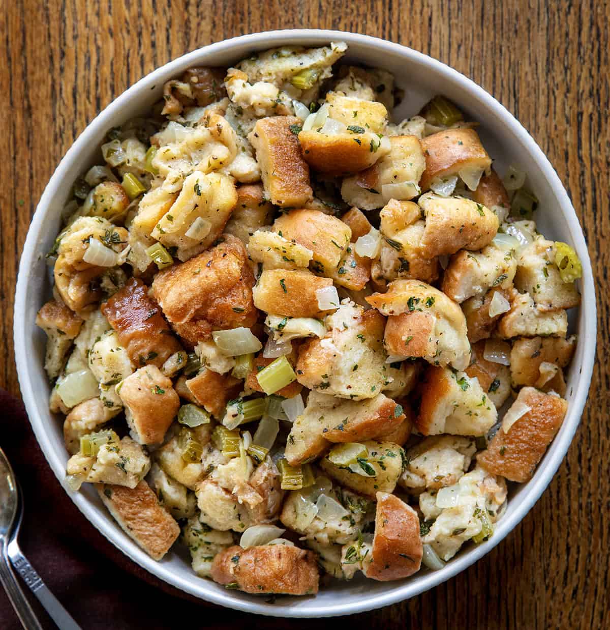 Bowl of Slow Cooker Stuffing on a wooden table Bowl of Slow Cooker Stuffing on a wooden table.