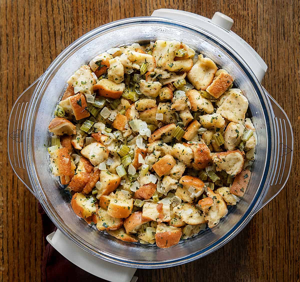Slow Cooker Stuffing on a wooden table from overhead Slow Cooker Stuffing on a wooden table from overhead.